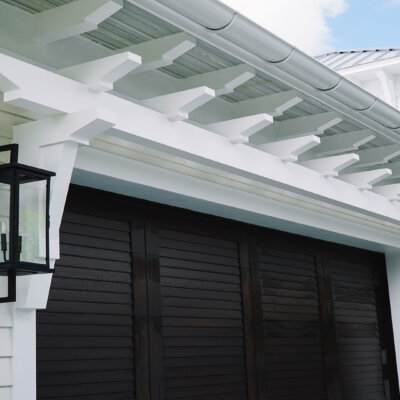 PVC Trellis on top of garage on florida home by hardie boys
