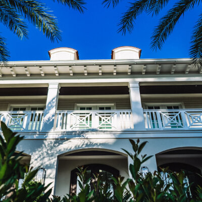 British indies style home with column wraps, rafter tails and soffit system.