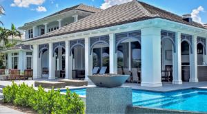 Home with vinyl louvers and vinyl column wraps on and tongue and groove soffit.